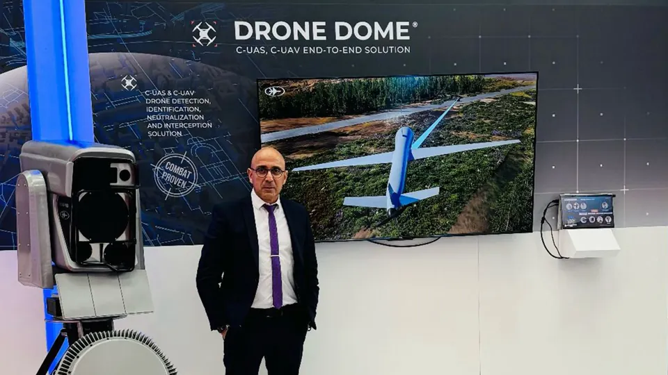 Stand detail - A display screen and equipment beneath Drone Dome graphics.